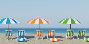 3d rendering. Beautiful beach. Chairs on the sandy beach near the sea. Summer holiday and vacation concept for tourism. Inspirational tropical landscape. Tranquil scenery, relaxing beach, tropical landscape design