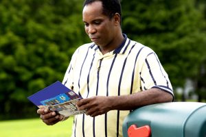5 essential print materials every Greenville nonprofit needs. Photo of man opening mailbox